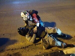 motorcyclist lying on road after accident